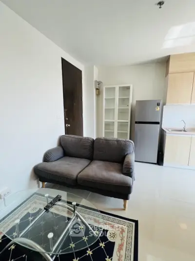 Modern apartment interior with cozy sofa and sleek kitchen area