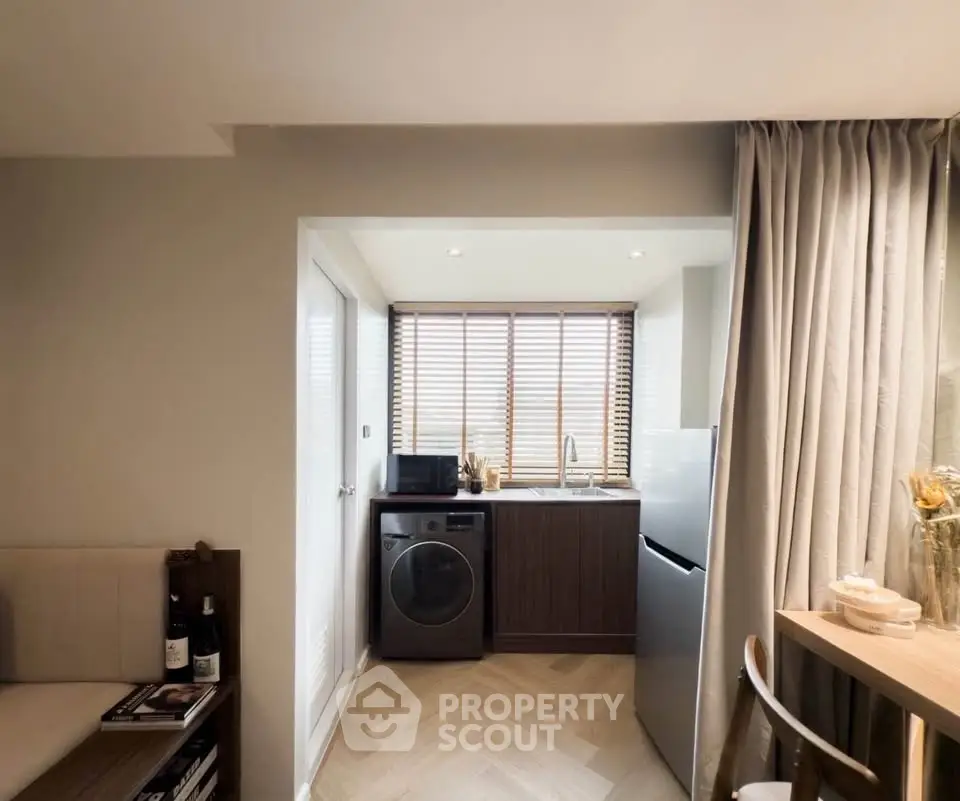 Chic compact kitchen with modern appliances and cozy dining area