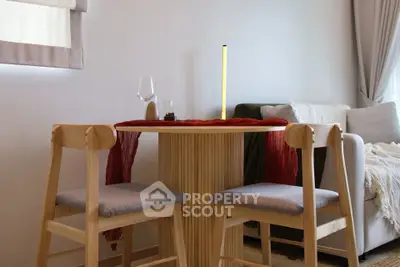 Chic modern living room with cozy seating and stylish dining area, perfect for urban living.