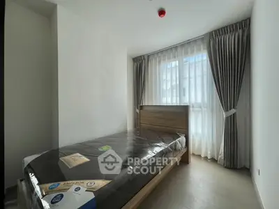 Modern bedroom with natural light and elegant curtains in a stylish apartment.