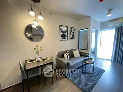 Modern living room with stylish decor and dining area in a cozy apartment setting.