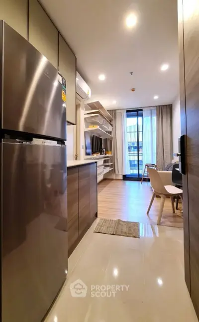 Modern open-layout kitchen and living room with sleek design and natural light