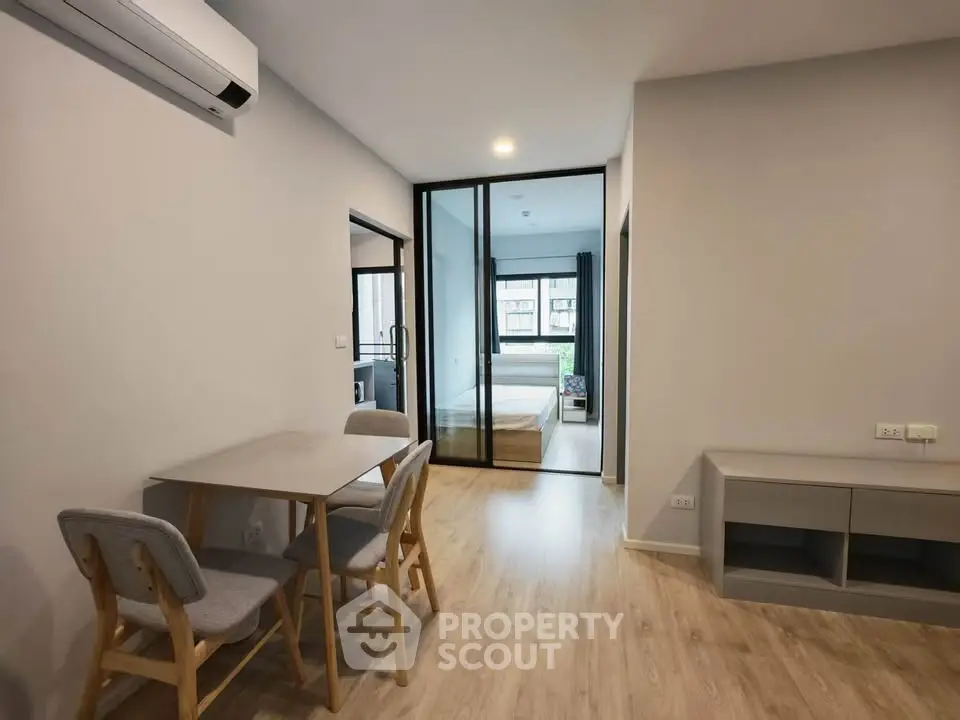 Modern apartment interior with dining area and bedroom view