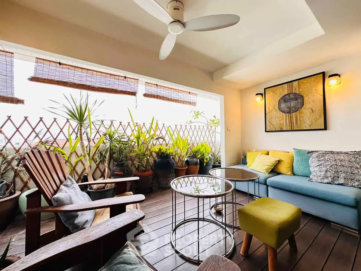 Charming balcony with cozy seating and lush plants, perfect for relaxation.