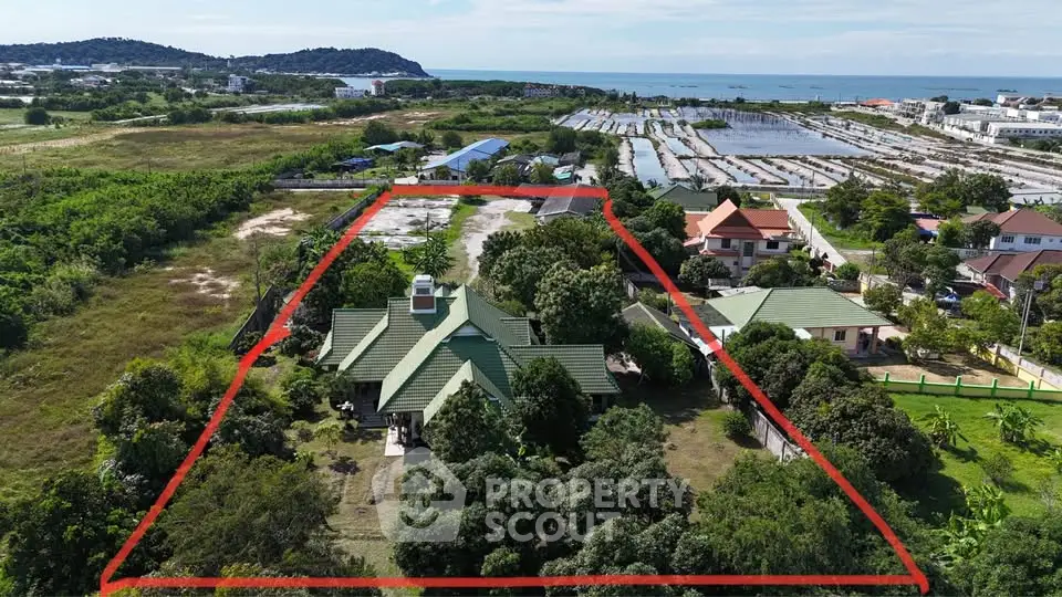 Expansive property with lush greenery and ocean view, ideal for development or private estate.