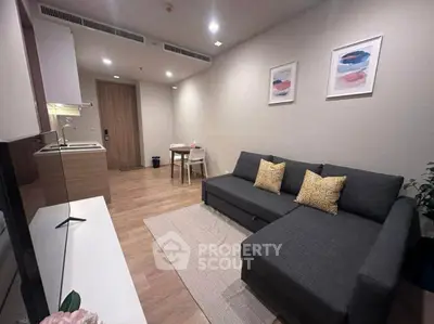 Modern living room with stylish sofa and open kitchen layout