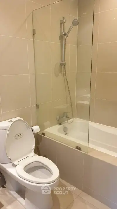 Modern bathroom with glass shower and bathtub in sleek design