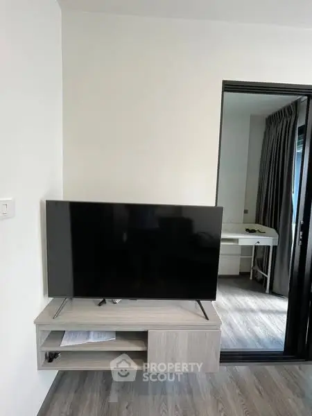 Modern living room with sleek TV setup and stylish flooring