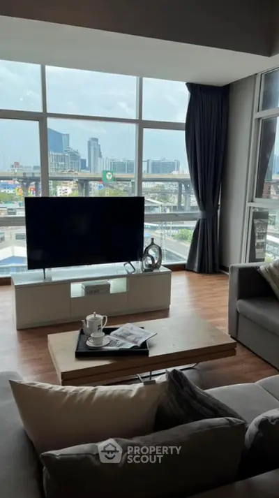 Modern living room with large windows and city view