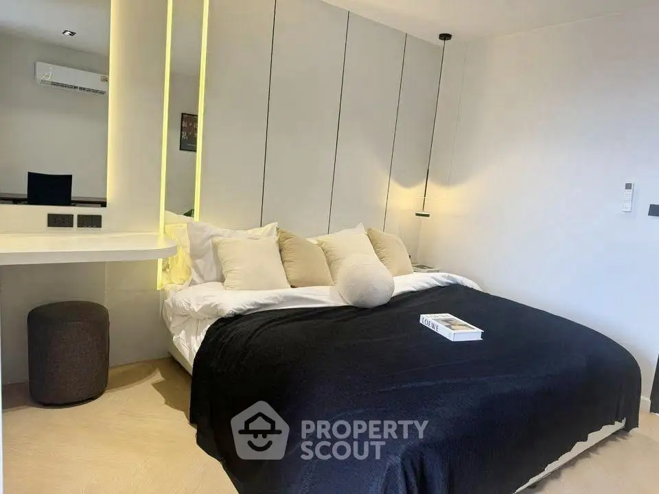 Modern bedroom with stylish decor and cozy ambiance, featuring a comfortable bed and elegant lighting.