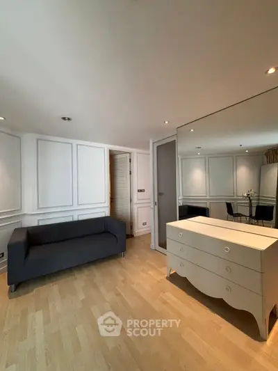 Chic living room with elegant paneling and stylish furniture in modern apartment.