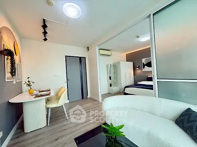 Modern open-plan living room with stylish decor and cozy bedroom view
