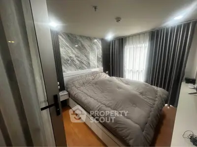 Modern bedroom with stylish decor and large windows for natural light