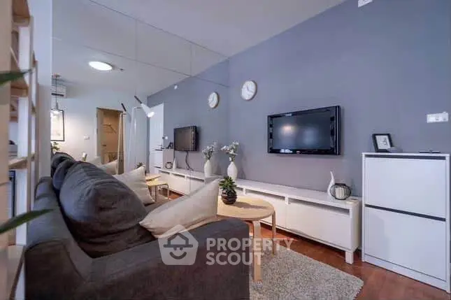 Modern living room with sleek decor and wall-mounted TV