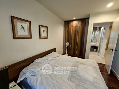 Cozy bedroom with wooden wardrobe and modern decor
