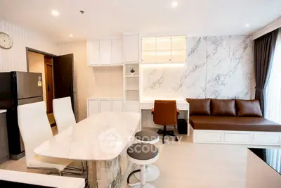Modern open-layout living room with marble accents and stylish furniture