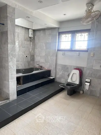 Spacious bathroom with bathtub and modern fixtures in a real estate property