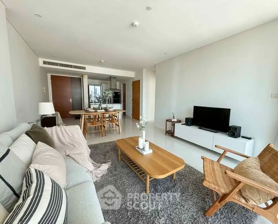 Spacious modern living room with stylish furniture and open kitchen layout