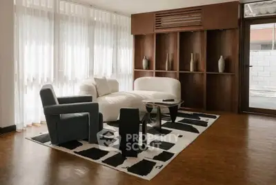Stylish modern living room with elegant furniture and large windows, perfect for relaxation and entertaining.