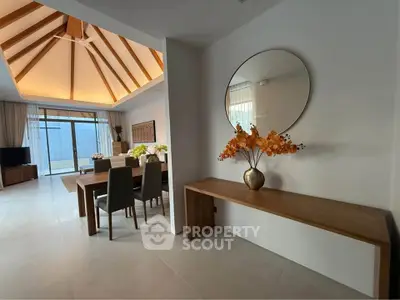 Spacious modern living room with vaulted ceiling and elegant dining area