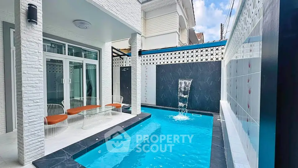 Luxurious private pool area with modern design and waterfall feature, perfect for relaxation and entertainment.