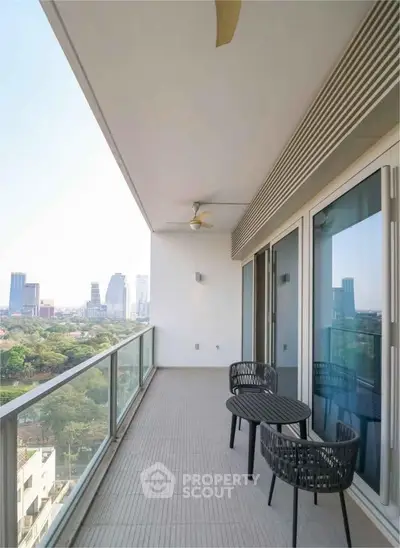 Spacious balcony with city view and modern outdoor furniture