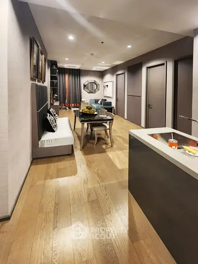 Modern open-layout living and dining area with stylish decor and wooden flooring.
