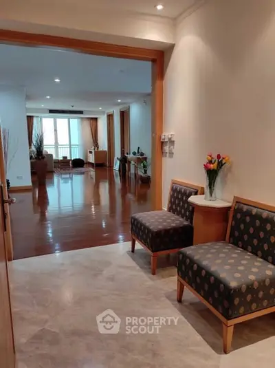 Spacious living room with polished wooden floors and elegant decor