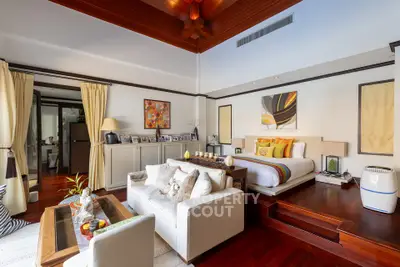 Luxurious bedroom with elegant decor and cozy seating area, perfect for relaxation.