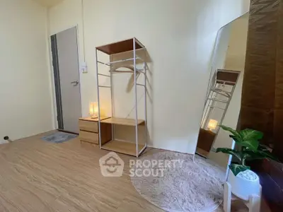 Cozy minimalist bedroom with wooden flooring and modern decor