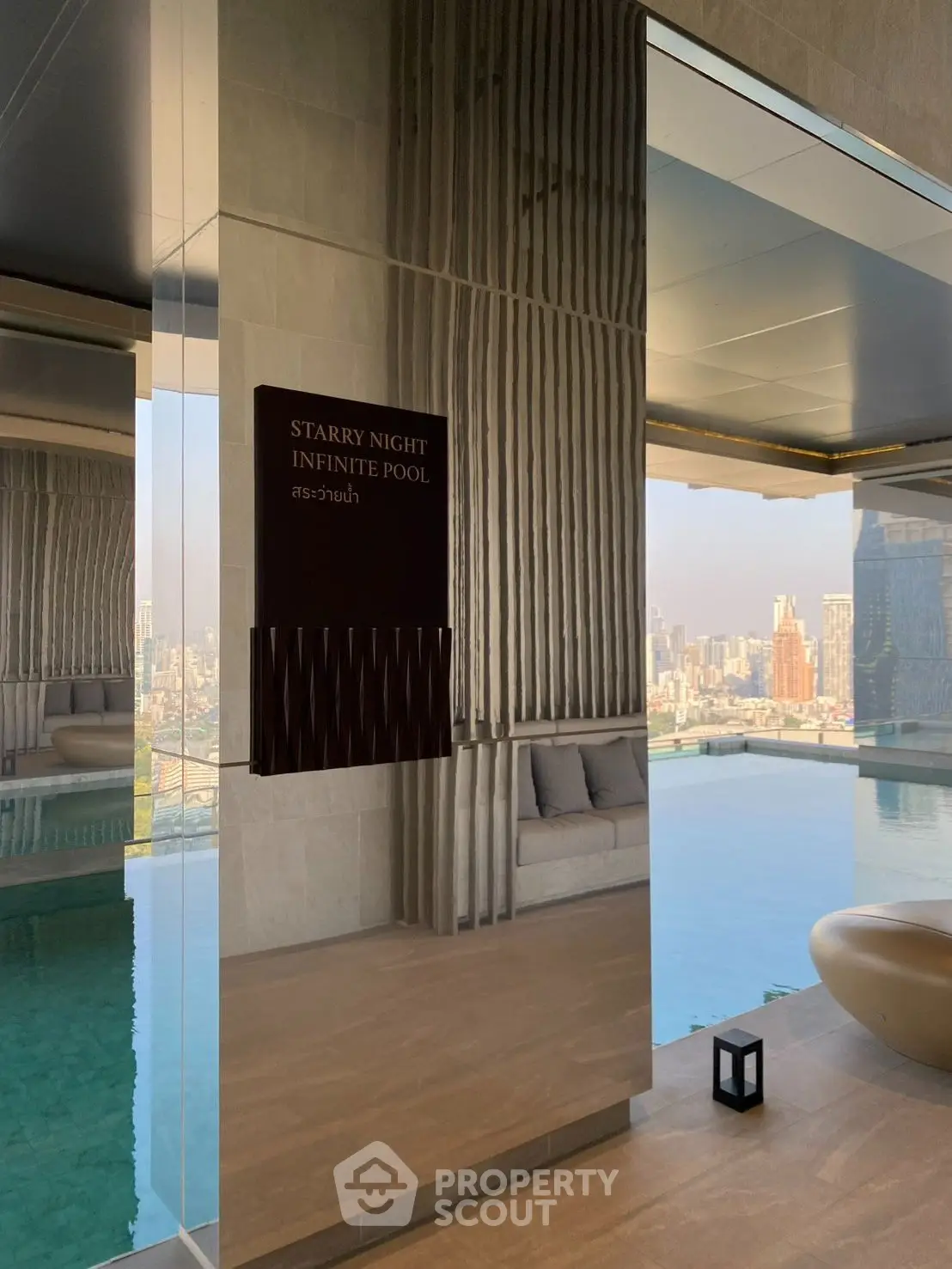 Luxurious infinity pool with stunning cityscape view in modern high-rise building.