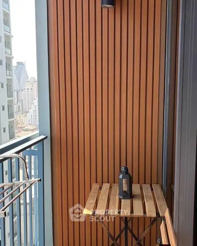 Chic urban balcony with wooden paneling and city view, perfect for relaxation.