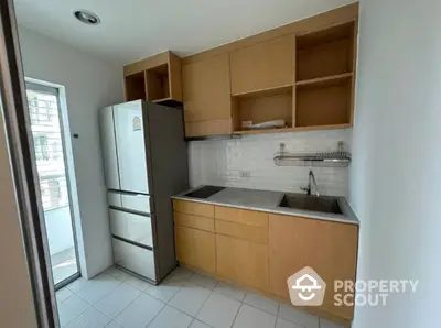 Compact kitchen space with modern appliances and ample cabinetry, featuring a clean design and a practical layout for efficient cooking.