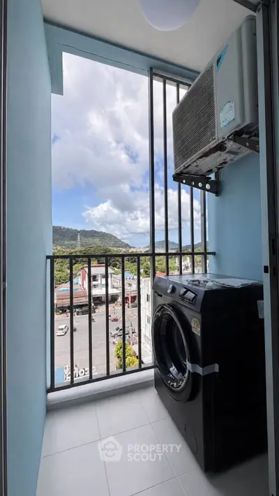 Charming balcony with scenic view and modern washing machine, perfect for urban living.