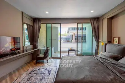 Luxurious bedroom with balcony access and modern decor