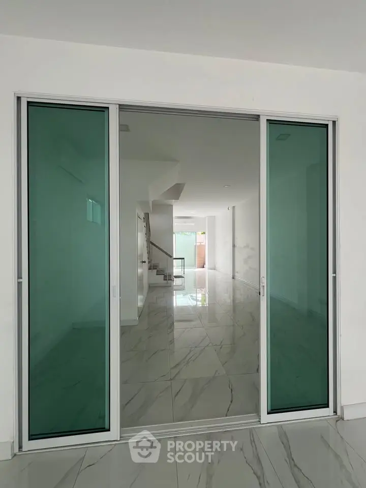 Spacious modern interior with sliding glass doors and marble flooring
