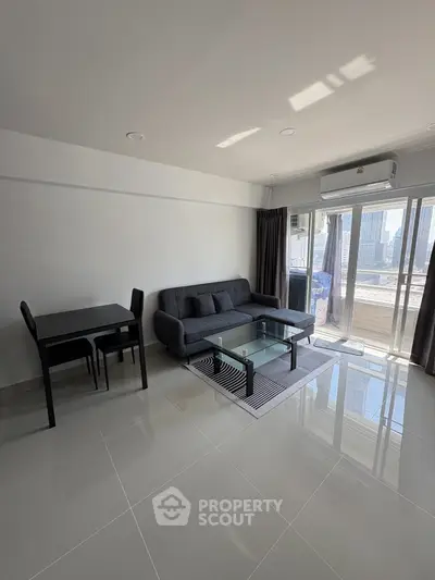 Modern living room with sleek furniture and large windows offering ample natural light.