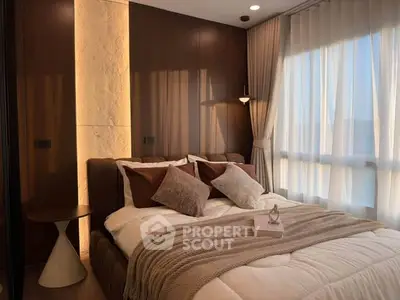 Luxurious bedroom with elegant lighting and cozy decor in modern apartment.
