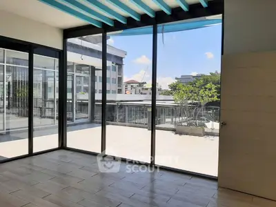 Spacious modern room with large windows and balcony view