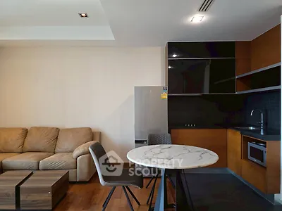 Modern living room with sleek kitchen and cozy seating area