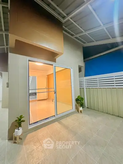 Spacious balcony with sliding glass doors and modern design