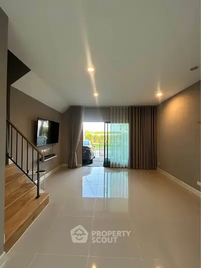 Spacious modern living room with sleek design and large windows for natural light.