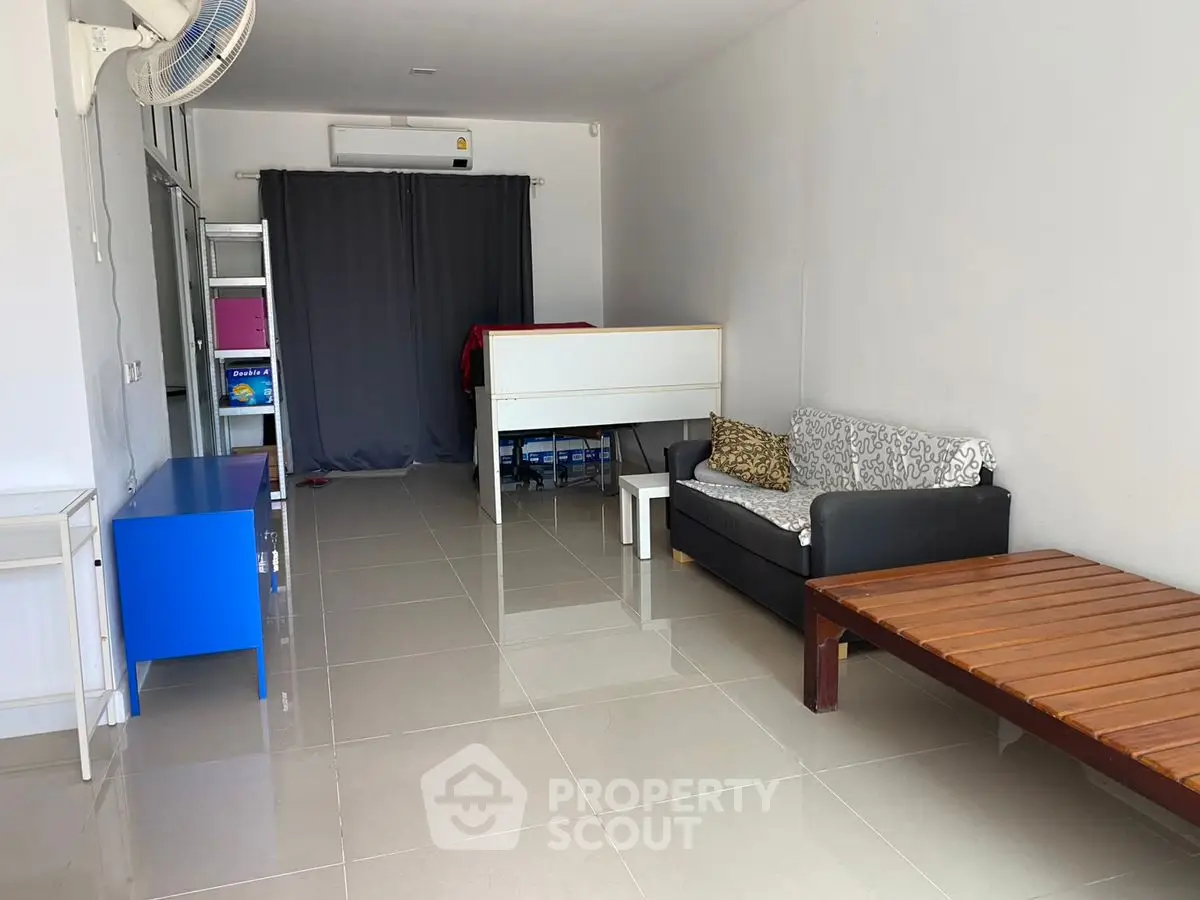 Spacious living room with modern furniture and tiled flooring