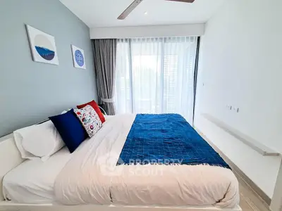 Modern bedroom with stylish decor and large window for natural light