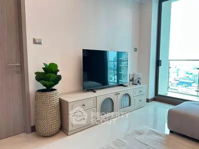 Modern living room with sleek TV stand and large window offering city view