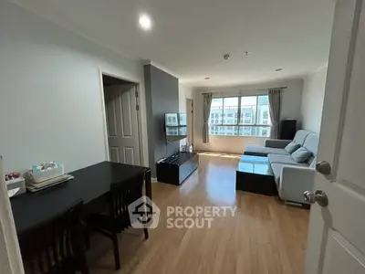Spacious living room with modern decor and large windows offering natural light.