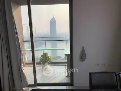 Stunning high-rise apartment with balcony offering breathtaking city and river views, perfect for urban living.