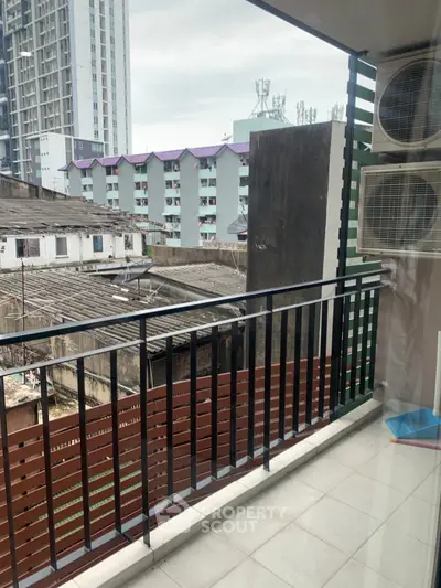 Urban balcony view with air conditioning units and cityscape backdrop, ideal for modern living.