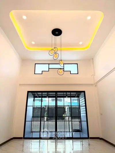 Stunning modern living room with high ceiling and elegant lighting