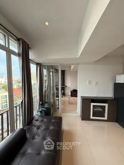 Spacious modern living room with city view and sleek furnishings